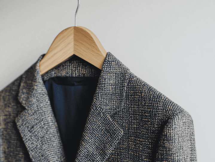 A shopper browsing through a rack of Frank and Eileen clothing in a boutique