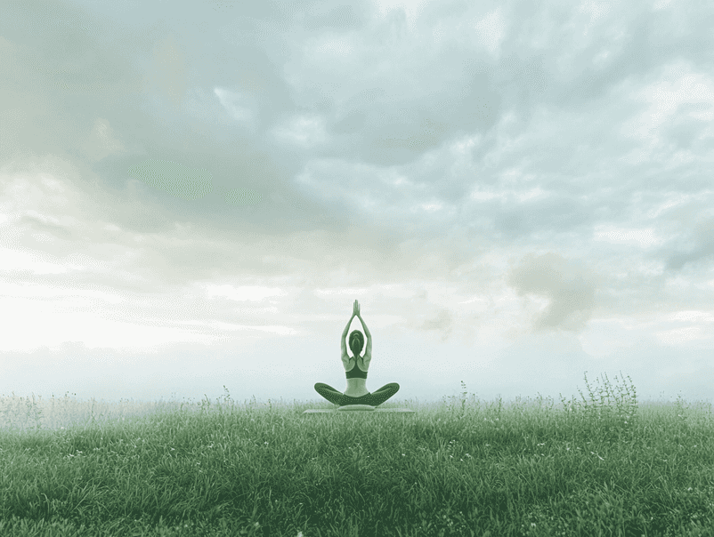 A serene yoga session in a peaceful outdoor setting, representing balance and recovery
