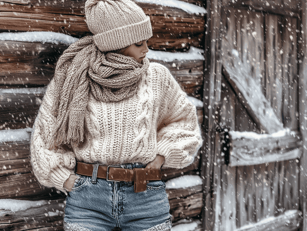 A stylish winter outfit featuring leather pants and a cozy knit sweater