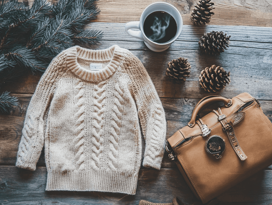 A stylish winter outfit featuring a chunky knit sweater and tailored coat