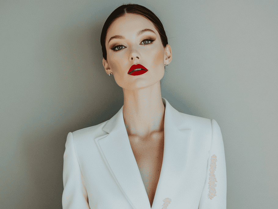 A bride in a tailored white suit with minimalist accessories